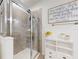 Elegant bathroom featuring a glass-enclosed shower with stylish tile work and modern fixtures at 8635 Tallfield Ave, Orlando, FL 32832