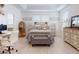 Bright main bedroom featuring a comfortable bed, white walls, and a designated desk area at 8635 Tallfield Ave, Orlando, FL 32832