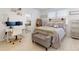 Bright main bedroom featuring a comfortable bed, white walls, and a designated desk area at 8635 Tallfield Ave, Orlando, FL 32832