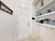 The mud room offers built-in shelving and storage for organization with convenient coat hooks and a tiled floor at 8635 Tallfield Ave, Orlando, FL 32832