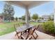 Covered patio area with a wooden table and chairs at 8635 Tallfield Ave, Orlando, FL 32832