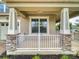 Inviting front porch with stone accents on the columns, providing a cozy outdoor space with a white railing detail at 8635 Tallfield Ave, Orlando, FL 32832
