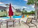 A recreational splash pad provides a fun water activity area for families, with colorful chairs, umbrellas, and lounge chairs at 8635 Tallfield Ave, Orlando, FL 32832