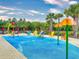 Community splash pad featuring colorful water features, seating, and lush landscaping, creating a fun and relaxing environment at 8635 Tallfield Ave, Orlando, FL 32832
