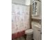 Cozy bathroom featuring a toilet, a sink, and a shower with a decorative curtain at 921 Alecon Dr, Orlando, FL 32808