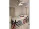 Comfortable bedroom with ceiling fan, neutral walls, and bed with stylish coral reef themed bedding at 921 Alecon Dr, Orlando, FL 32808