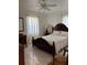 Inviting bedroom featuring marble floors, a comfortable bed, and a rustic wooden dresser at 921 Alecon Dr, Orlando, FL 32808