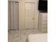 Simple yet stylish bedroom featuring tiled floors, closet, and sleek white dresser at 921 Alecon Dr, Orlando, FL 32808
