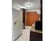 Functional kitchen features white appliances including refrigerator and microwave oven plus dark wood cabinets at 921 Alecon Dr, Orlando, FL 32808