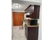 Compact kitchen featuring dark cabinets, granite countertops, and essential appliances at 921 Alecon Dr, Orlando, FL 32808