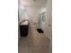 Bright bathroom with double sinks, a glass-enclosed shower, and tiled flooring at 1895 Hickory Bluff Rd, Kissimmee, FL 34744