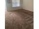 Cozy bedroom with natural light from a large window and neutral carpet flooring at 1895 Hickory Bluff Rd, Kissimmee, FL 34744