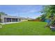 Spacious backyard featuring a screened-in patio and lush green lawn at 1013 Carefree Cove Dr, Winter Haven, FL 33881