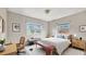 Bright and airy bedroom with hardwood floors, featuring calming decor and natural light from the windows at 1013 Carefree Cove Dr, Winter Haven, FL 33881