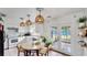 Bright kitchen with white cabinets, stainless steel appliances, and a dining table at 1013 Carefree Cove Dr, Winter Haven, FL 33881