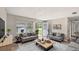 Staged living room with seating, a front view, and recently updated floors at 1013 Carefree Cove Dr, Winter Haven, FL 33881
