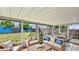 Inviting sunroom furnished with comfortable seating and views of the backyard at 1013 Carefree Cove Dr, Winter Haven, FL 33881