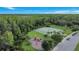 Aerial view of a community playground and tennis court surrounded by trees and lush landscaping at 10734 Dawson Lily Way # S, Orlando, FL 32832