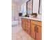 Elegant bathroom featuring a double vanity, framed mirrors, and glass-enclosed shower at 10734 Dawson Lily Way # S, Orlando, FL 32832