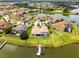 Waterfront home with a private dock and lush lawn, providing an idyllic lakeside living experience at 1110 Terralago Way, Kissimmee, FL 34746