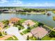 Beautiful aerial view of waterfront houses with tile roofs, green lawns, and boat docks at 1110 Terralago Way, Kissimmee, FL 34746