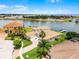 Beautiful waterfront home boasts lush landscaping, a brick driveway, and direct access to the serene lake and boat dock at 1110 Terralago Way, Kissimmee, FL 34746