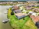 Aerial view of a waterfront home with a private dock and lush landscaping in a desirable community at 1110 Terralago Way, Kissimmee, FL 34746