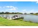 Waterfront backyard with private dock and boat, offering stunning views and direct lake access at 1110 Terralago Way, Kissimmee, FL 34746