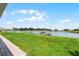 Expansive waterfront backyard with lush green grass and private dock, perfect for outdoor enjoyment at 1110 Terralago Way, Kissimmee, FL 34746