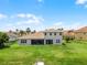 Back exterior showcasing the well-manicured lawn, and screened in porch at 1110 Terralago Way, Kissimmee, FL 34746
