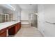 Spacious bathroom featuring dual sinks, a soaking tub, glass enclosed shower and a large mirror at 1110 Terralago Way, Kissimmee, FL 34746