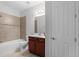 Neat bathroom featuring tiled shower, neutral walls, and white door at 1110 Terralago Way, Kissimmee, FL 34746