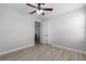 Well-lit bedroom featuring a ceiling fan, light walls, and wood-look flooring at 1110 Terralago Way, Kissimmee, FL 34746