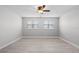 Bright bedroom featuring two windows, wood-look floors, and ample space at 1110 Terralago Way, Kissimmee, FL 34746