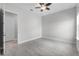 Bright bedroom featuring a ceiling fan and grey-toned floor tiles at 1110 Terralago Way, Kissimmee, FL 34746