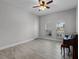 Cozy bedroom with arched windows, ceiling fan, and wood-look tile flooring at 1110 Terralago Way, Kissimmee, FL 34746