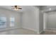 Clean and simple bedroom with arched windows, ceiling fan, and tile flooring at 1110 Terralago Way, Kissimmee, FL 34746