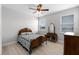 Charming bedroom with a classic wood bed frame and abundant natural light at 1110 Terralago Way, Kissimmee, FL 34746