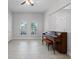 Bedroom featuring a piano, arched windows, ceiling fan, and tile flooring at 1110 Terralago Way, Kissimmee, FL 34746