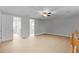Well-lit bonus room area with wood flooring, ceiling fan, and hallway access at 1110 Terralago Way, Kissimmee, FL 34746