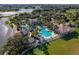 Aerial view of community pool area featuring swimming pools, a clubhouse, and lush landscaping at 1110 Terralago Way, Kissimmee, FL 34746