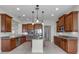 Gourmet kitchen with stainless steel appliances, granite countertops, and a center island at 1110 Terralago Way, Kissimmee, FL 34746
