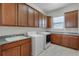 Spacious laundry room with granite countertops, sink, and washer/dryer at 1110 Terralago Way, Kissimmee, FL 34746