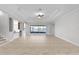 Spacious living room with a view of the water, tray ceiling, tiled floor, and lots of natural light at 1110 Terralago Way, Kissimmee, FL 34746