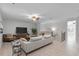 Bright living room featuring sleek furniture, wood floors, and a ceiling fan at 1110 Terralago Way, Kissimmee, FL 34746