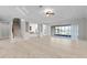 Bright living room with elegant flooring, staircase, and sliding doors to a patio with a water view at 1110 Terralago Way, Kissimmee, FL 34746