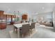Open-concept living and dining area features wood cabinets, stainless appliances, and a comfortable seating area at 1110 Terralago Way, Kissimmee, FL 34746