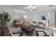Cozy living room showcasing stylish decor, a fan, and wood flooring at 1110 Terralago Way, Kissimmee, FL 34746