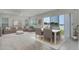 Living and dining area featuring comfortable seating, stylish decor, and picturesque water views at 1110 Terralago Way, Kissimmee, FL 34746