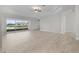 Spacious living room features tile flooring, sliding glass doors to a lanai, and water view at 1110 Terralago Way, Kissimmee, FL 34746